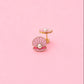 Earrings with a pink shell and pearl on a pink background