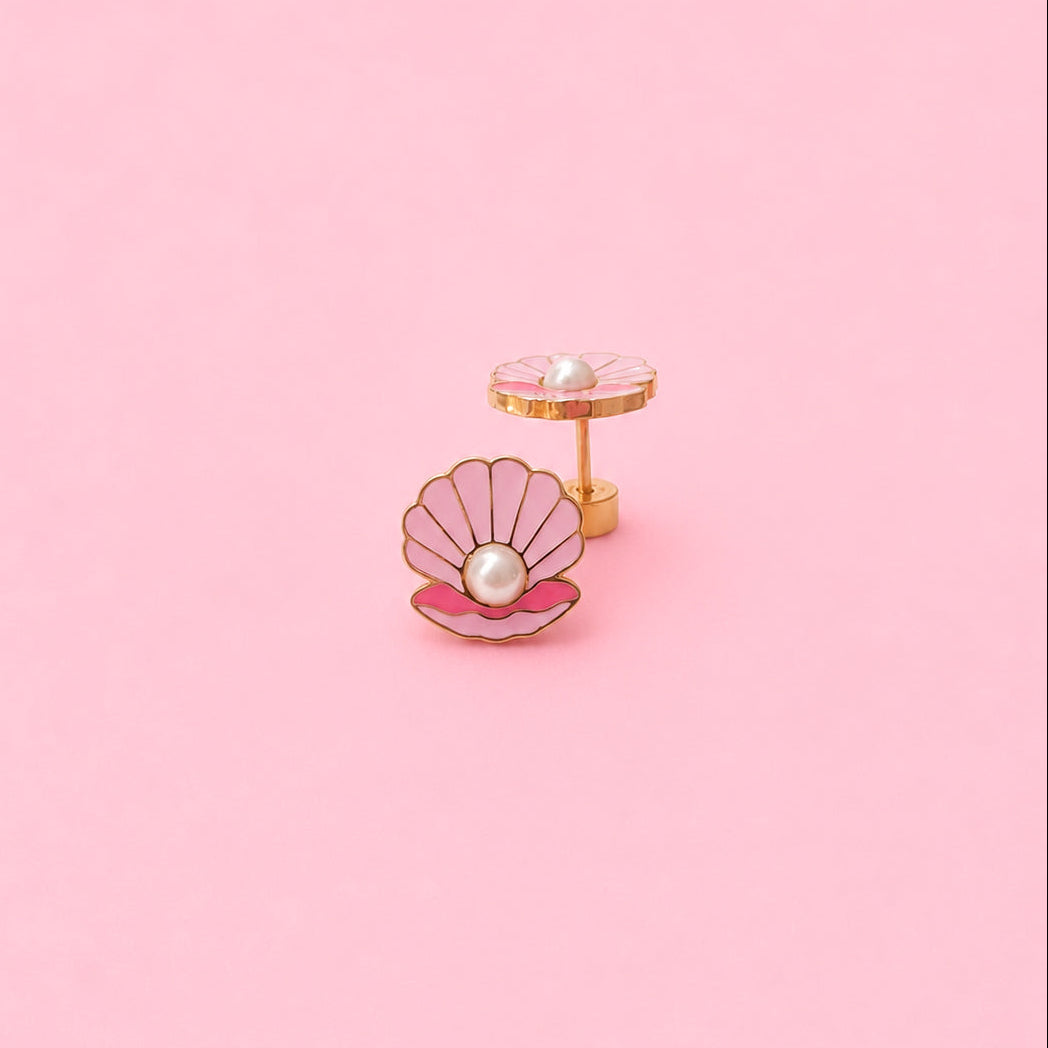 Earrings with a pink shell and pearl on a pink background