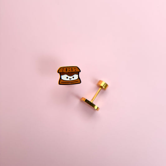 Kawaii s'mores-shaped earrings on a pink background