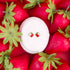 Strawberry blossom studs on a white jewelry box on a bed of strawberries