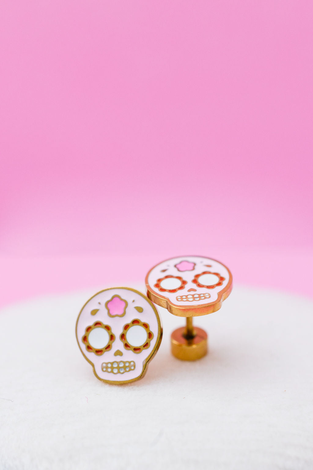 Sugar skull stud earrings close-up
