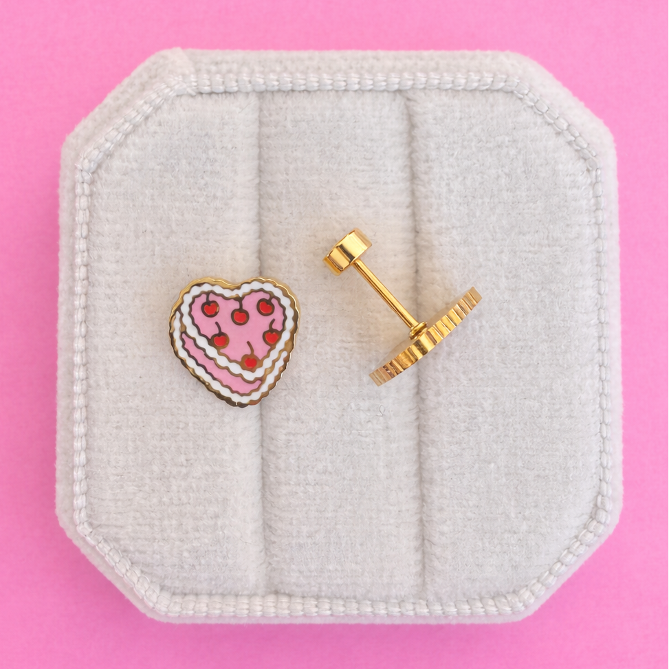 vintage heart cake studs on white jewelry box with pink background