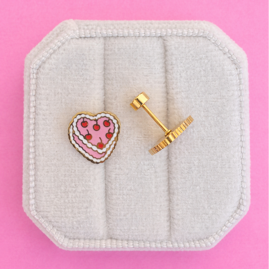 vintage heart cake studs on white jewelry box with pink background
