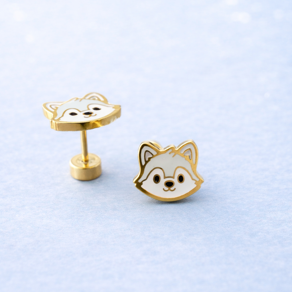 Wolf face studs on a light blue background