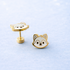 Wolf face studs on a light blue background
